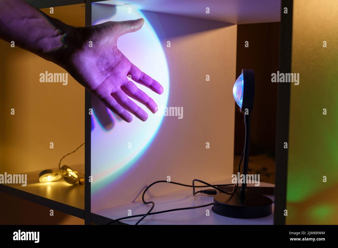 Sunset projector lamp. Multi colored RGB light. Home decor, interior. Selective focus Stock Photo