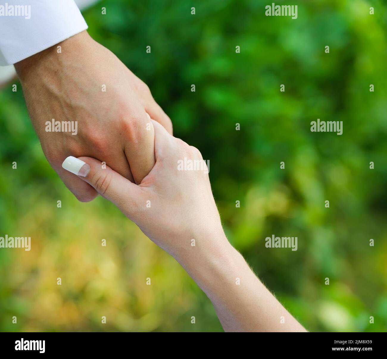 Man hold a woman fingers by the hand. male assista Stock Photo - Alamy