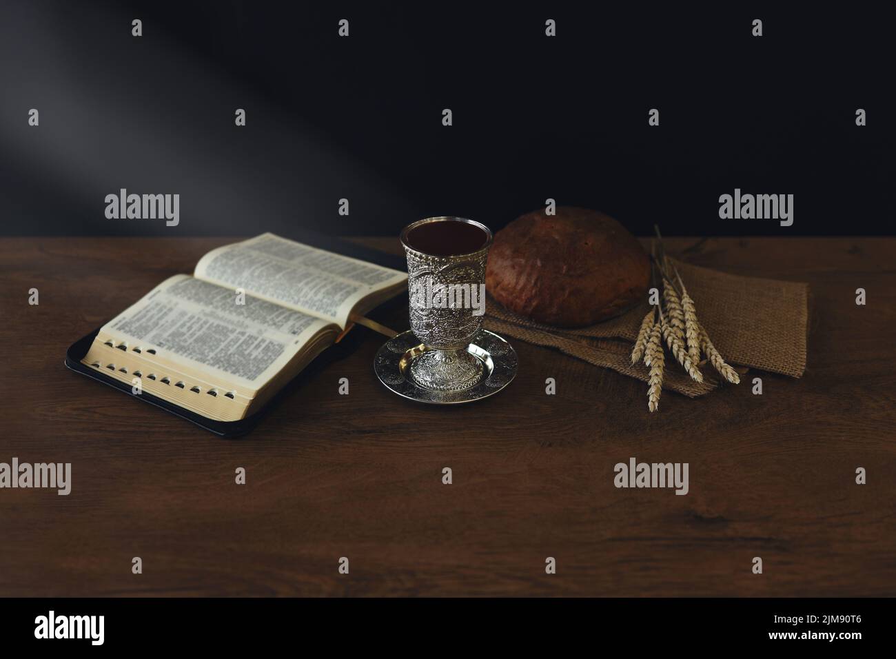 Chalice with wine and bread. Background with copy space. last supper