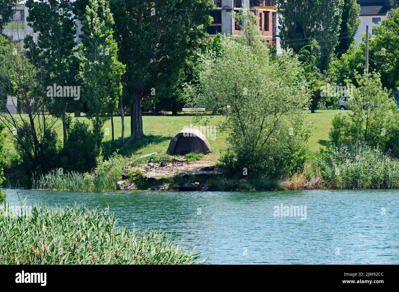 Springtime green on a fresh trees and lake in residential district Drujba, Sofia, Bulgaria Stock Photo