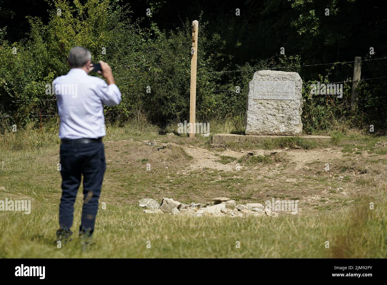 A man photographs the stone marking the spot for the traditional source ...
