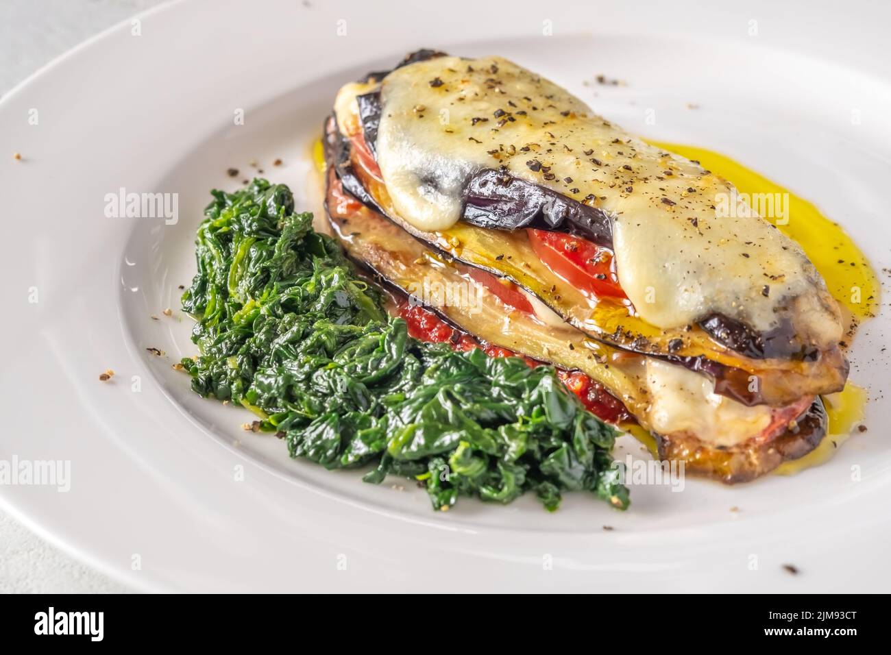 Cooked Eggplant Parmigiana with spinach on the plate Stock Photo Alamy