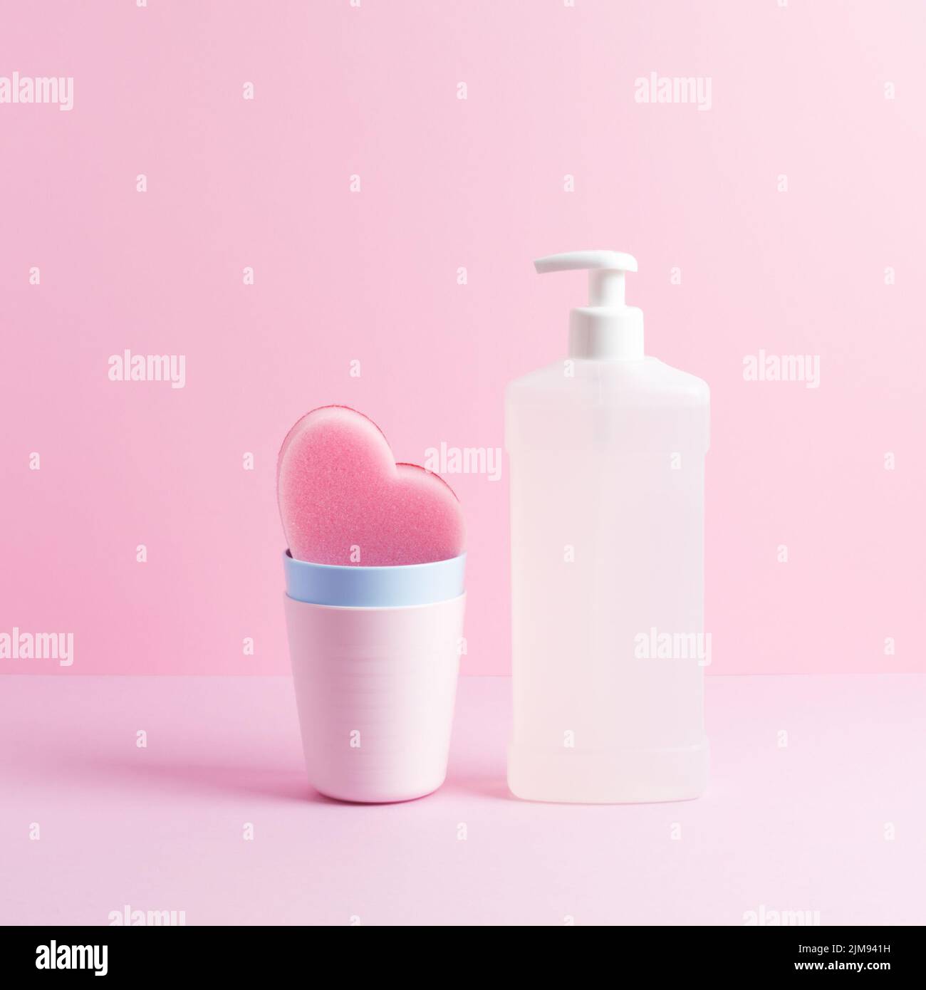 Square composition with dishwashing supplies. White bottle of dishwash