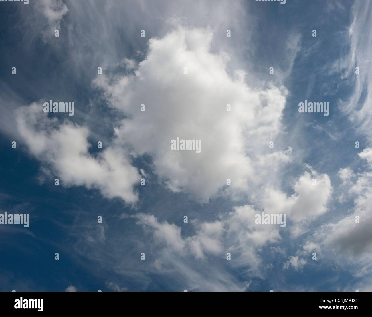 large white cotton ball clouds against a blue sy Stock Photo Alamy