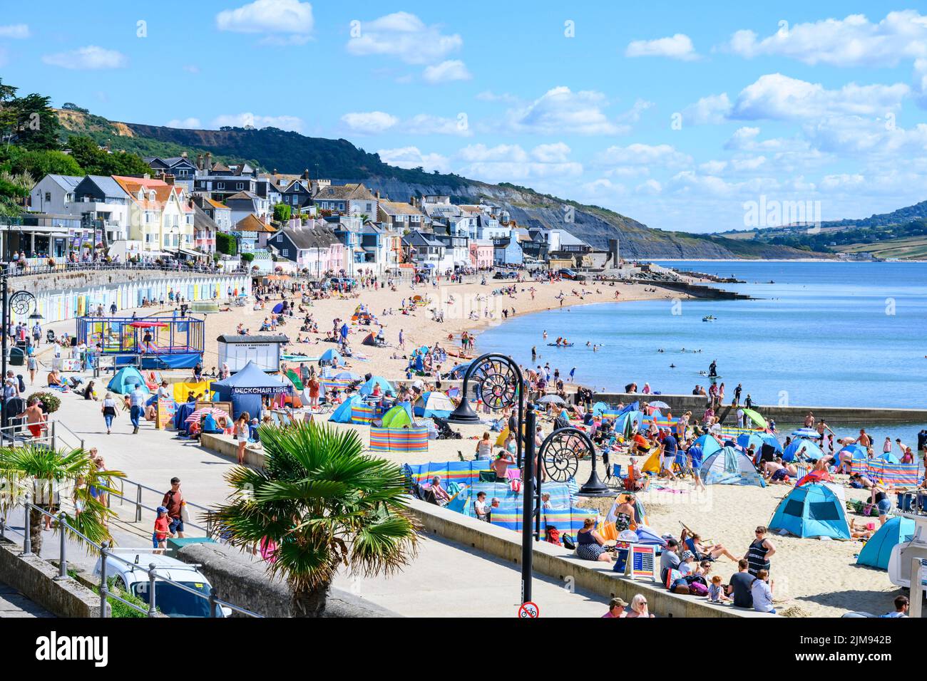Lyme Regis, Dorset, UK. 5th Aug, 2022. UK Weather: Crowds of holidaymakers and sunbathers flock to the beach to bask in scorching hot sunshine at the seaside resort of Lyme Regis. Credit: Celia McMahon/Alamy Live News Stock Photo