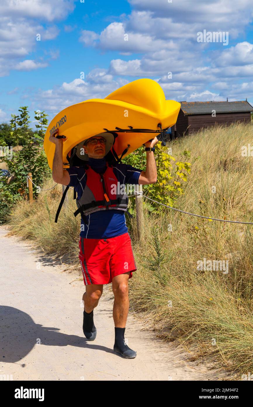 Knoll beach, Studland, Dorset UK. 5th August 2022. UK weather: warm and sunny at Studland beaches as sunseekers head to the seaside to enjoy the sunshine. A new hat or expecting rain??? Credit: Carolyn Jenkins/Alamy Live News Stock Photo