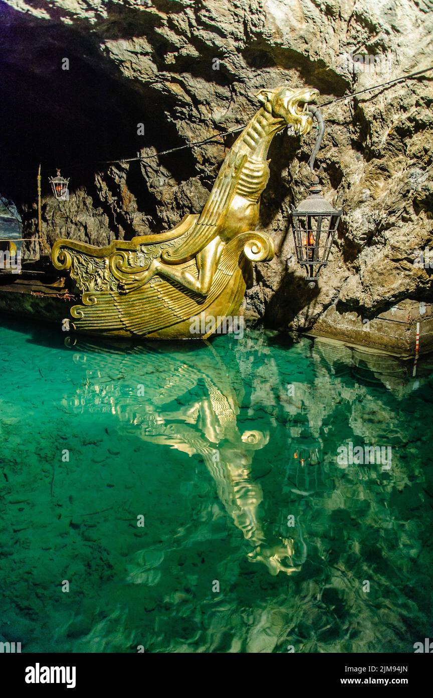 Underground Lake with golden Boat Stock Photo