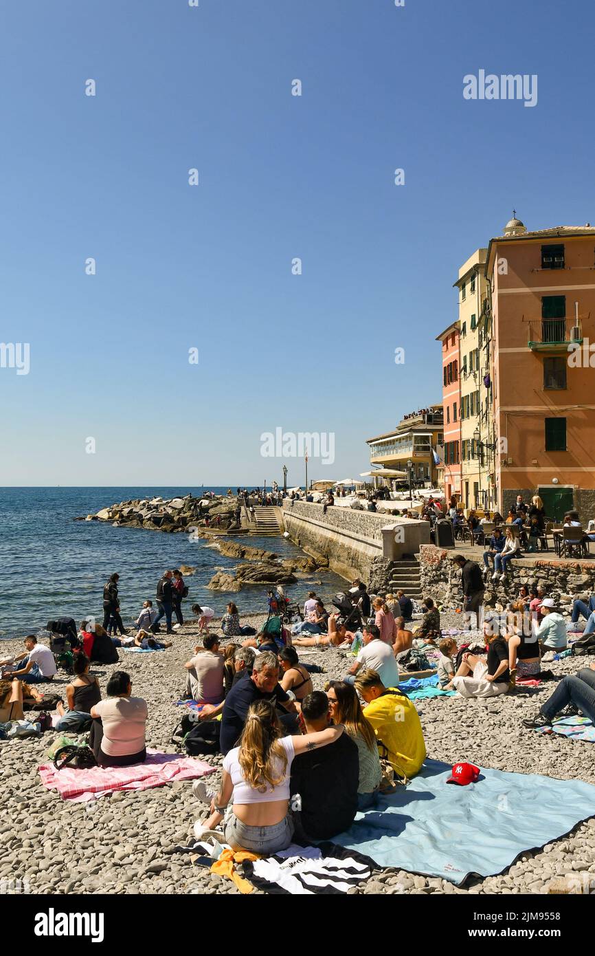 The small fishing village beach crowded with tourists on Easter Monday, Boccadasse, Genoa, Liguria, Italy Stock Photo