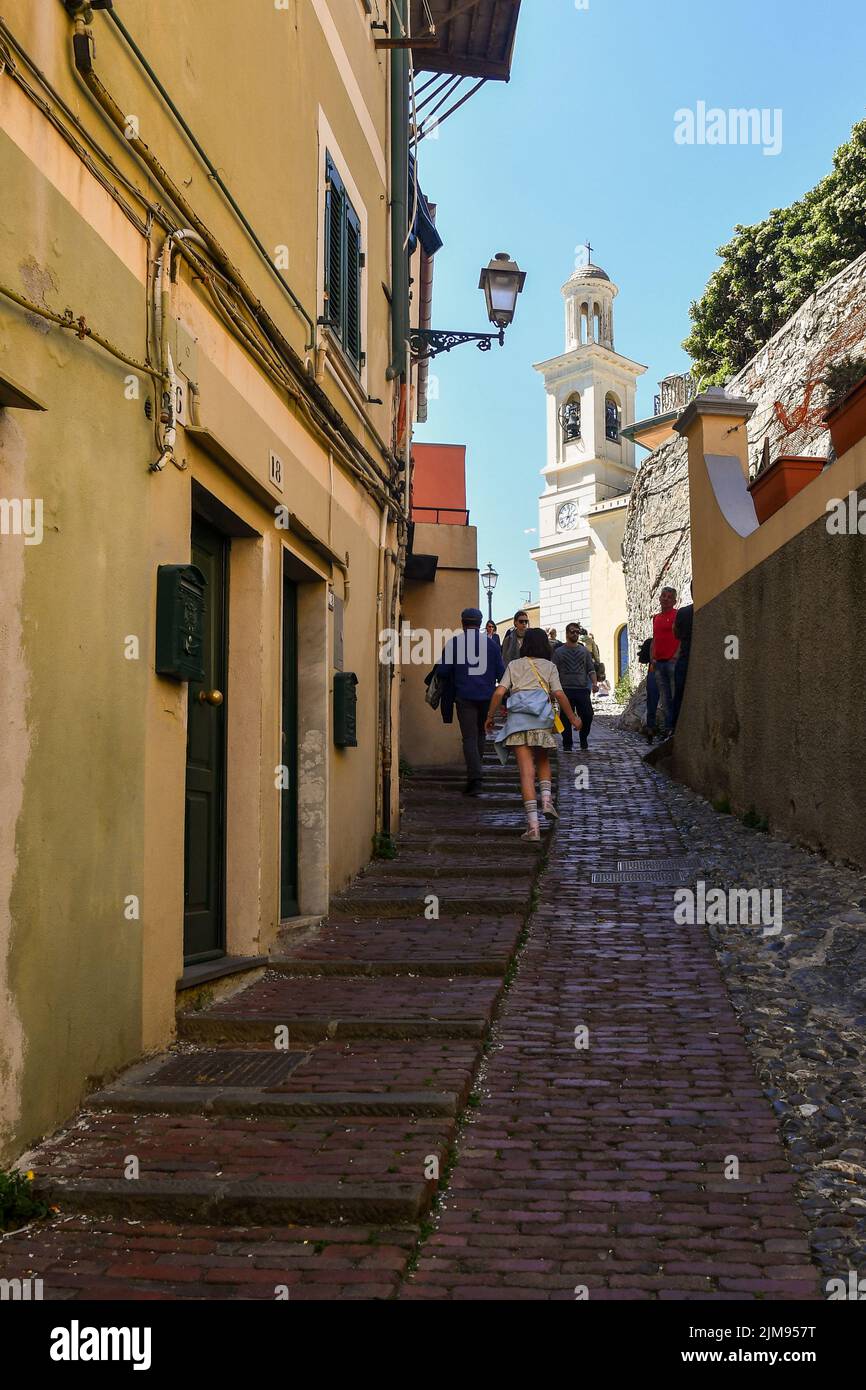 Uphill alley in the old fishing village with the bell tower of the church of Saint Anthony Stock Photo