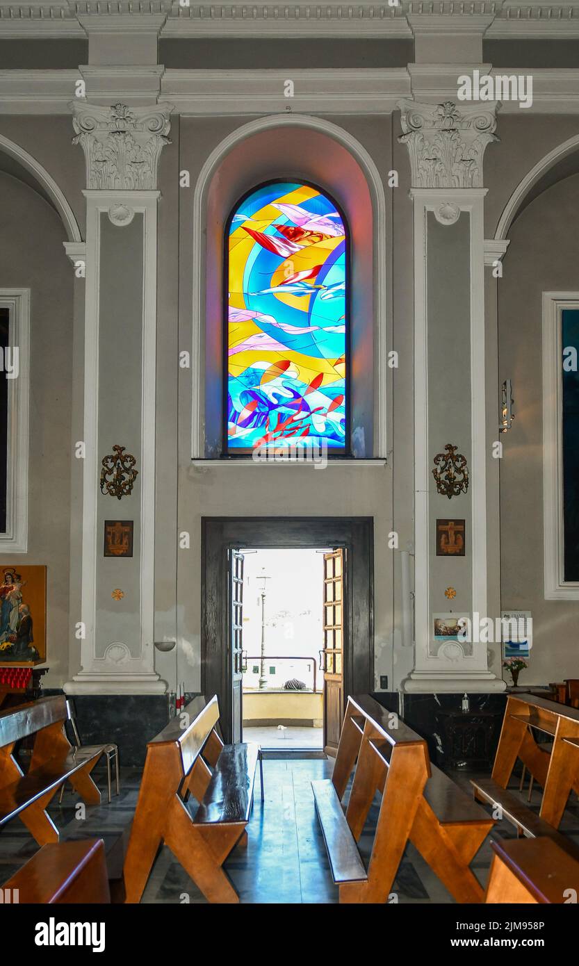 Interior of the church of Saint Anthony with a colorful stained-glass window, Boccadasse, Genoa, Liguria, Italy Stock Photo