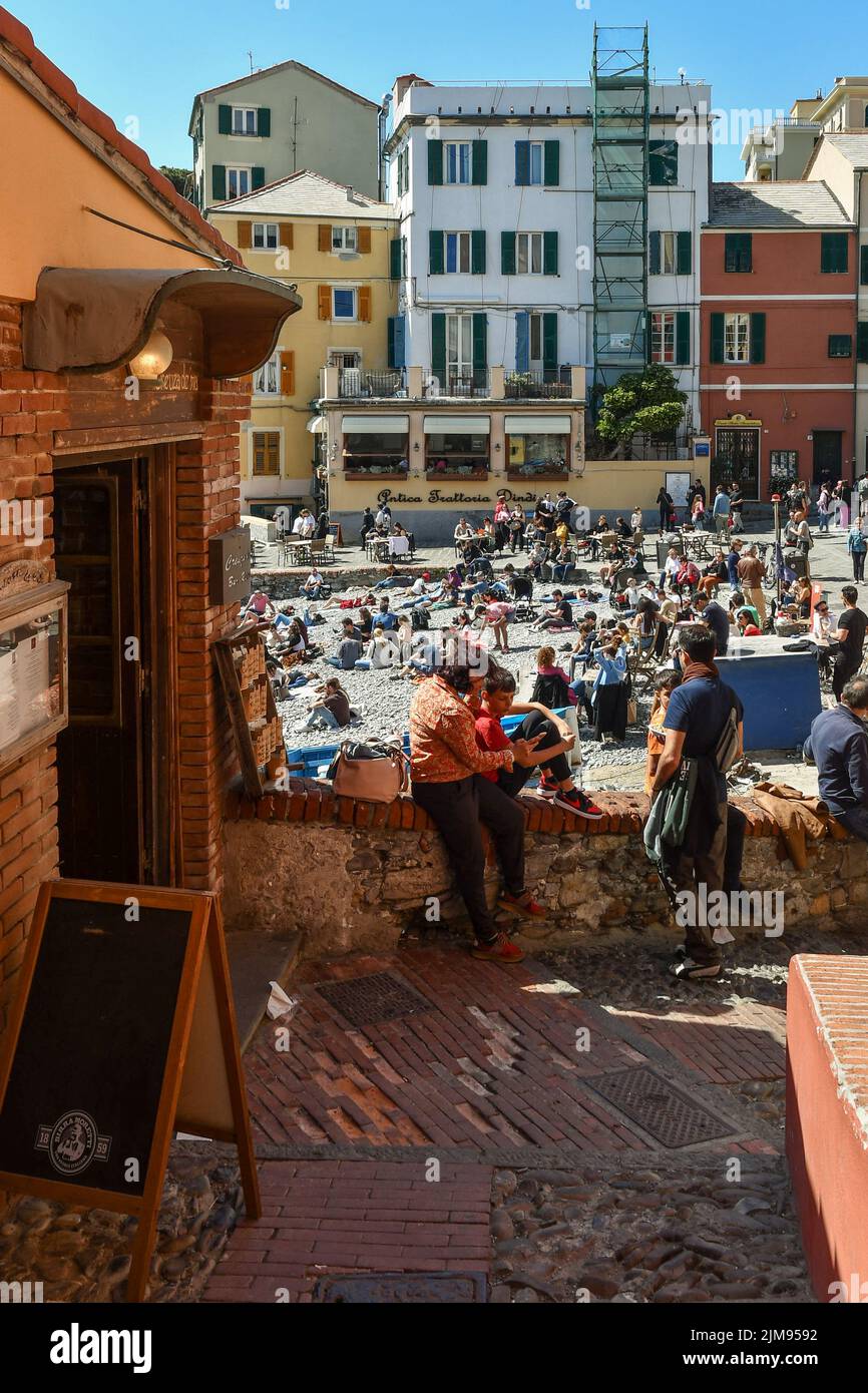 The old fishing village with the small beach a short distance from Genoa center crowded with tourists on Easter Monday, Boccadasse, Liguria, Italy Stock Photo