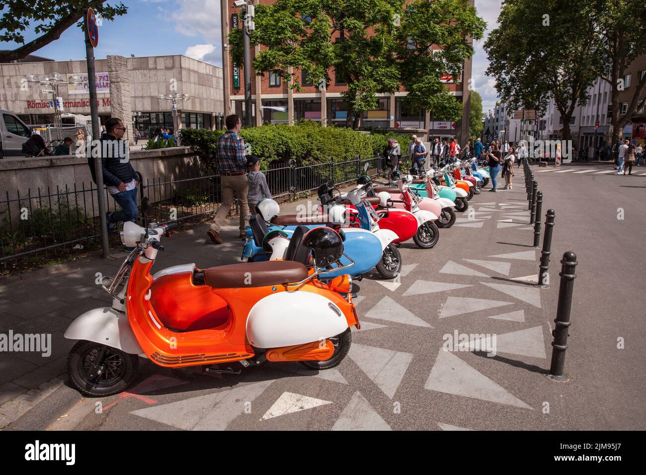 E-Vespina scooters with sidecars are available for rent for city tours near the cathedral, Cologne, Germany. E-Vespina Roller mit Seitenwagen stehen z Stock Photo