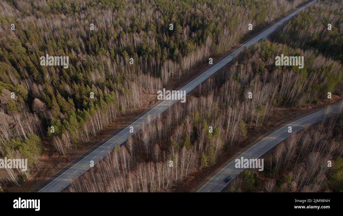 Multiple lane highway road with traffic cars between autumn forest in ...