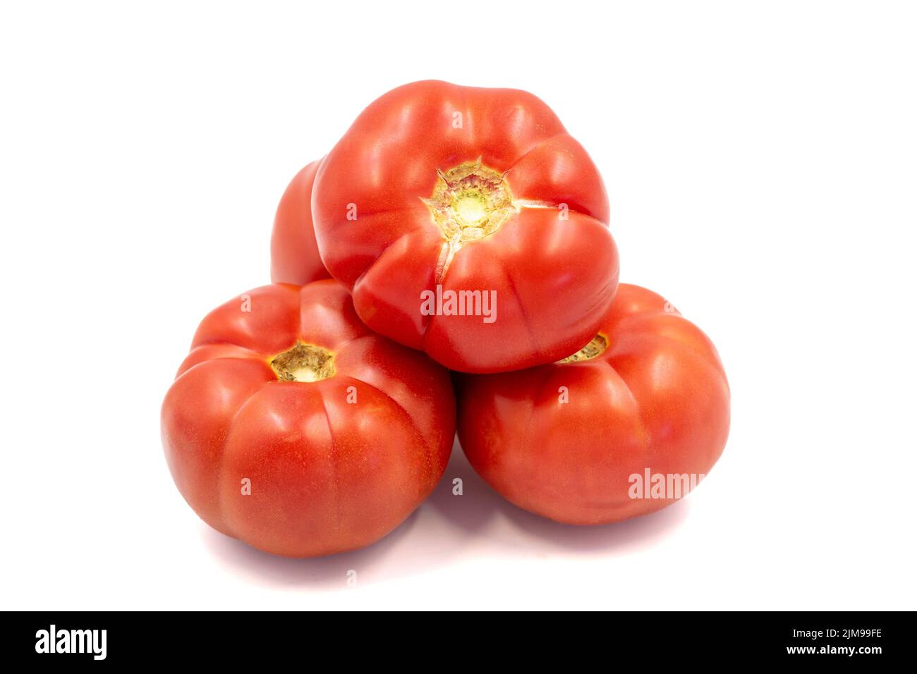 Ripe Tomatoes. Fresh and raw red tomatoes isolated on white background. Organic food. close up Stock Photo