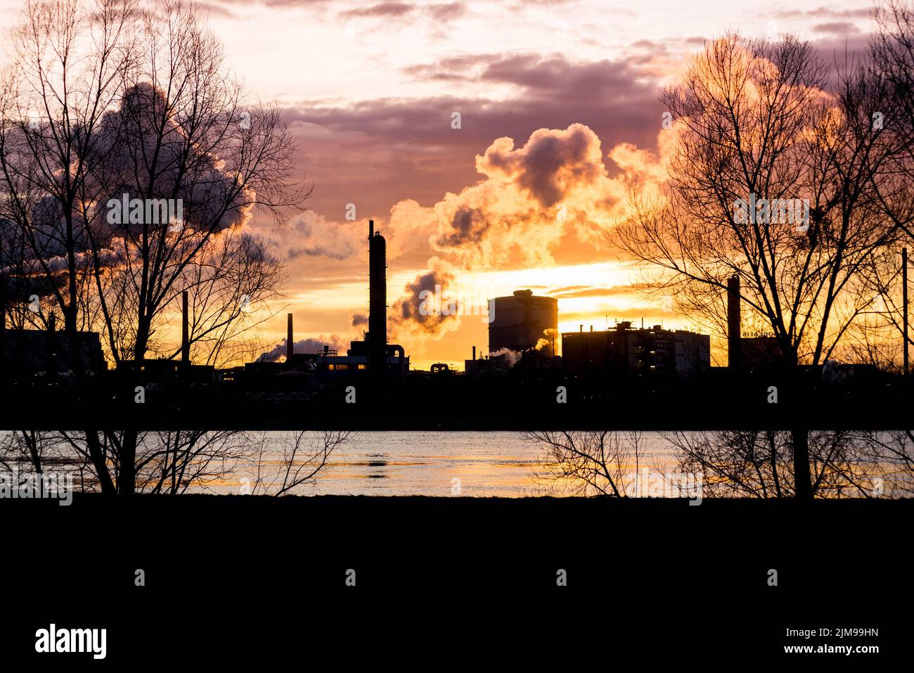 Factory with smokestacks at sunset Stock Photo