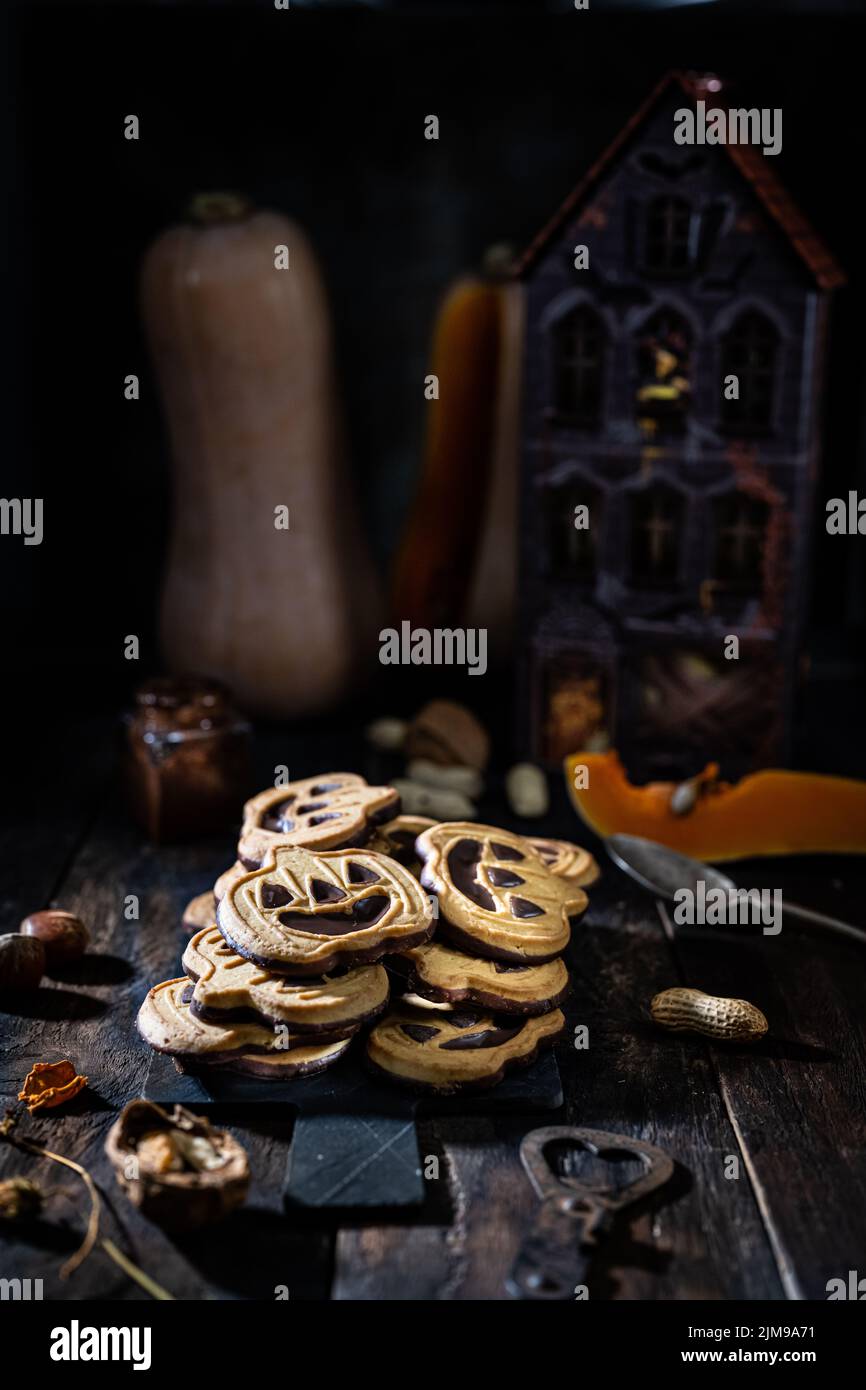 Halloween cookie.Cookies pumpkins with chocolate.Delicious food and drink.Sweet ghosts. Stock Photo