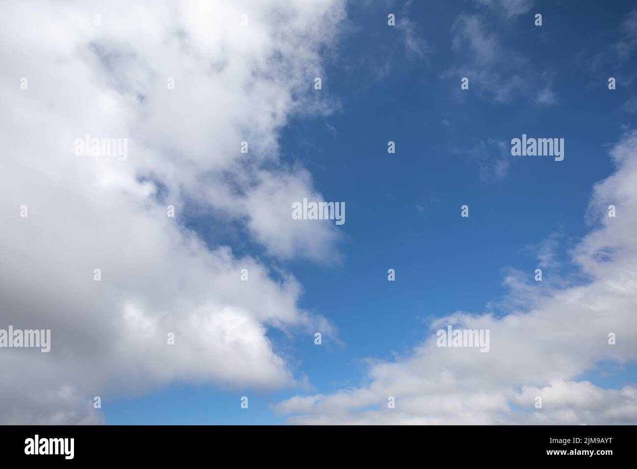White clouds on a clear blue sky Stock Photo
