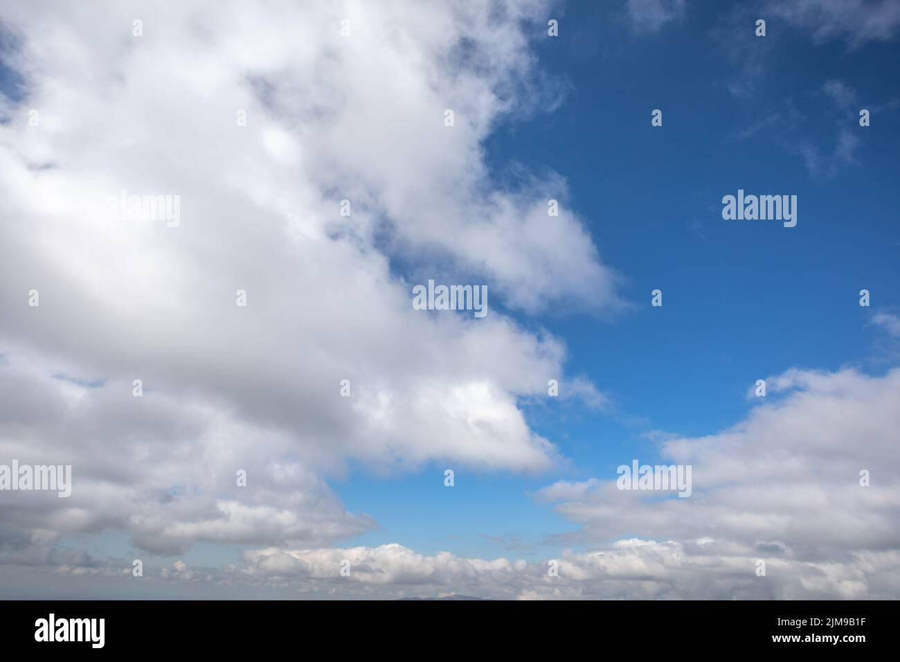 White clouds on a clear blue sky Stock Photo