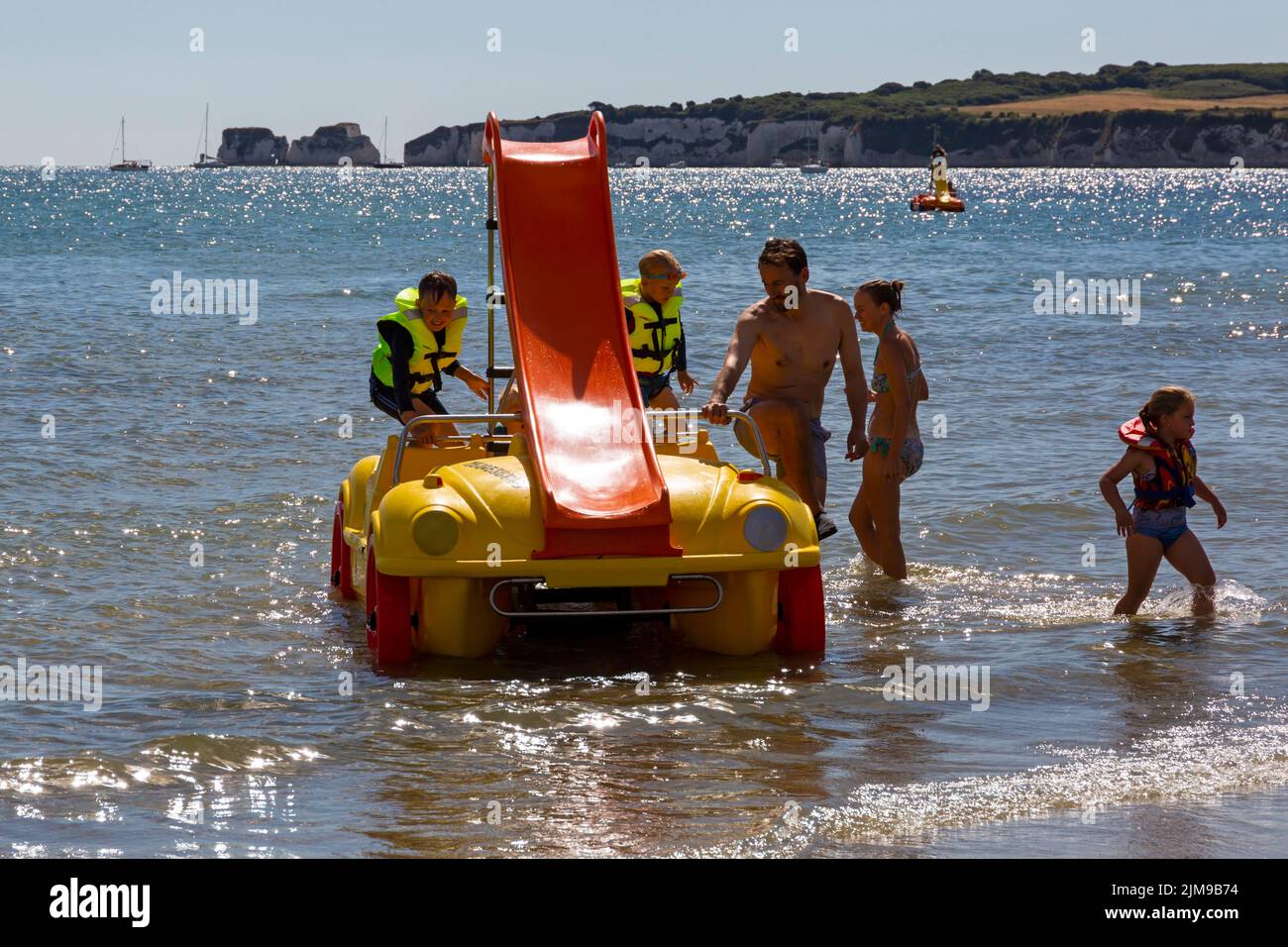Studland, Dorset UK. 5th August 2022. The new sea cars at Knoll beach, Studland prove to be a popular attraction; pedalos dressed as convertible cars, the first of its kind in the country. Eight are available to hire, four with slides and can take up to five people. A great fun way to travel without having to worry about the increasing costs of fuel! Credit: Carolyn Jenkins/Alamy Live News Stock Photo