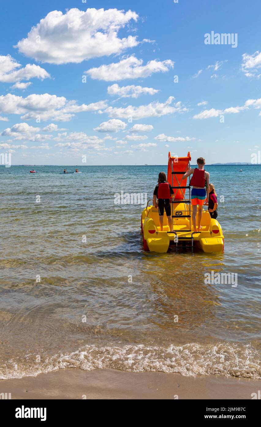Studland, Dorset UK. 5th August 2022. The new sea cars at Knoll beach, Studland prove to be a popular attraction; pedalos dressed as convertible cars, the first of its kind in the country. Eight are available to hire, four with slides and can take up to five people. A great fun way to travel without having to worry about the increasing costs of fuel! Credit: Carolyn Jenkins/Alamy Live News Stock Photo