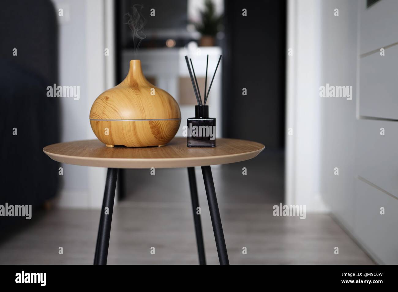 Aroma oil diffuser on table at home. Air freshener Stock Photo