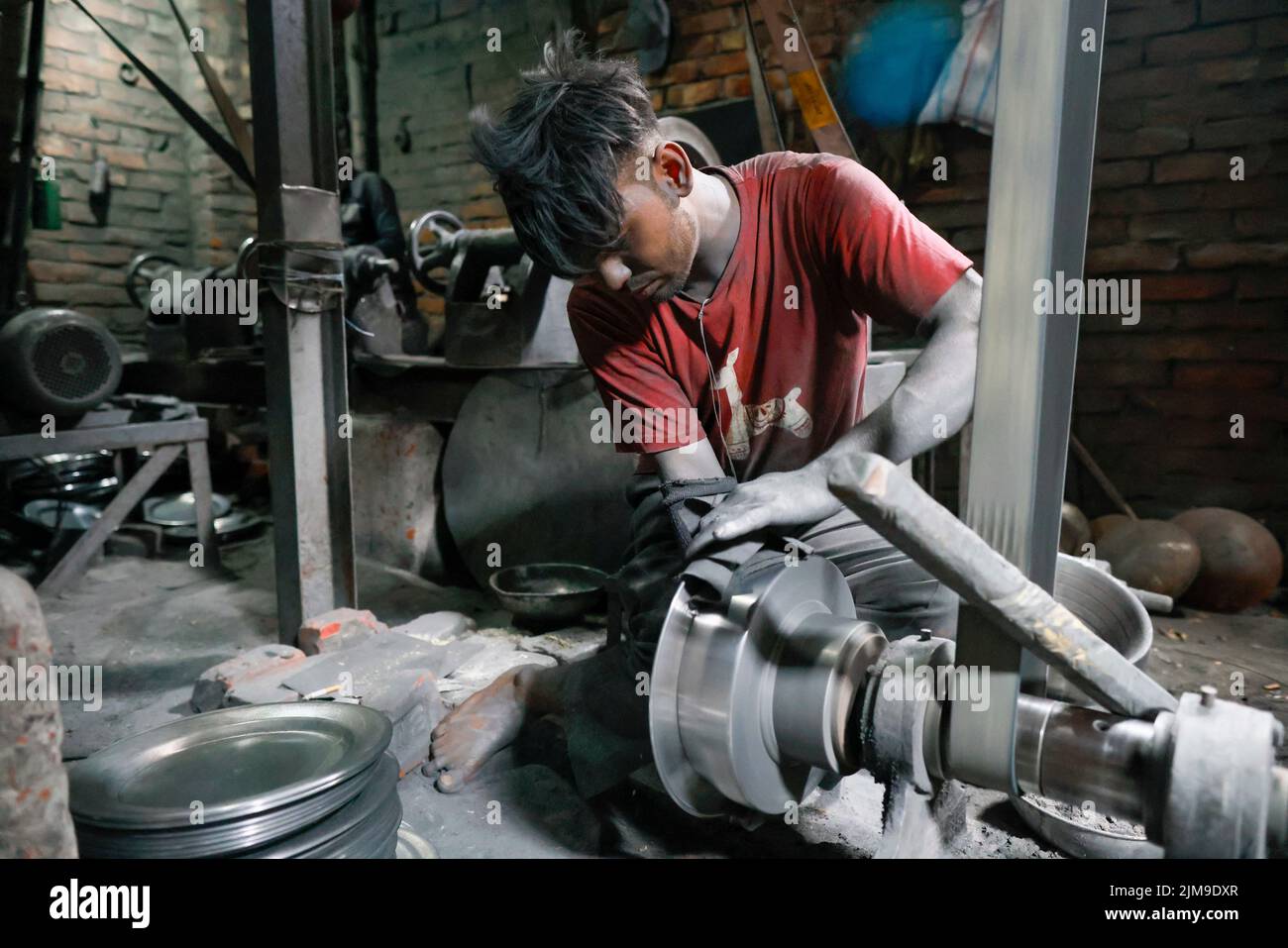 Bangladeshi workers make utensils in an unhealthy environment at an aluminum factory in Dhaka