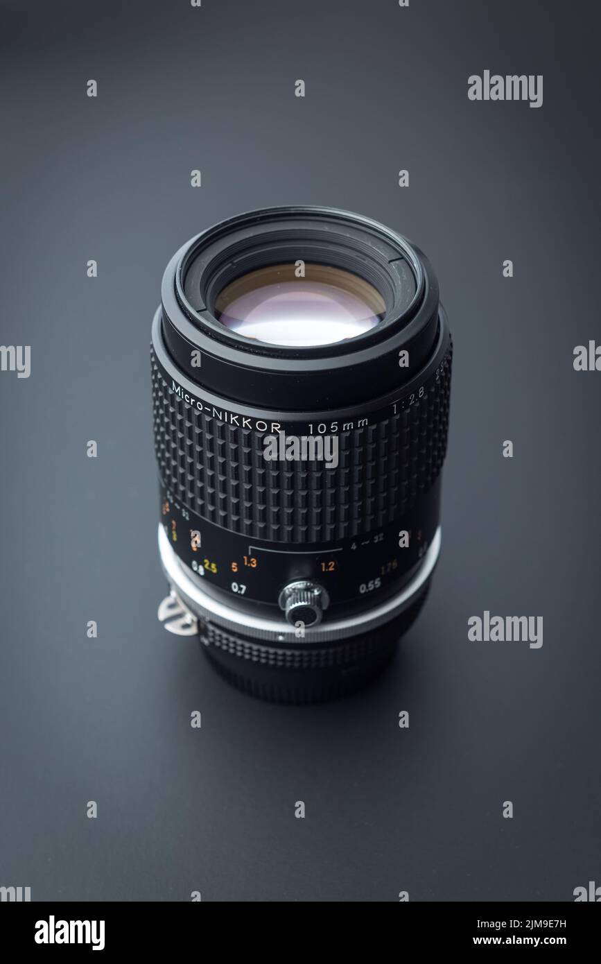 Nikon Micro-NIKKOR 105mm 2.8 manual focus lens on dark background Stock Photo