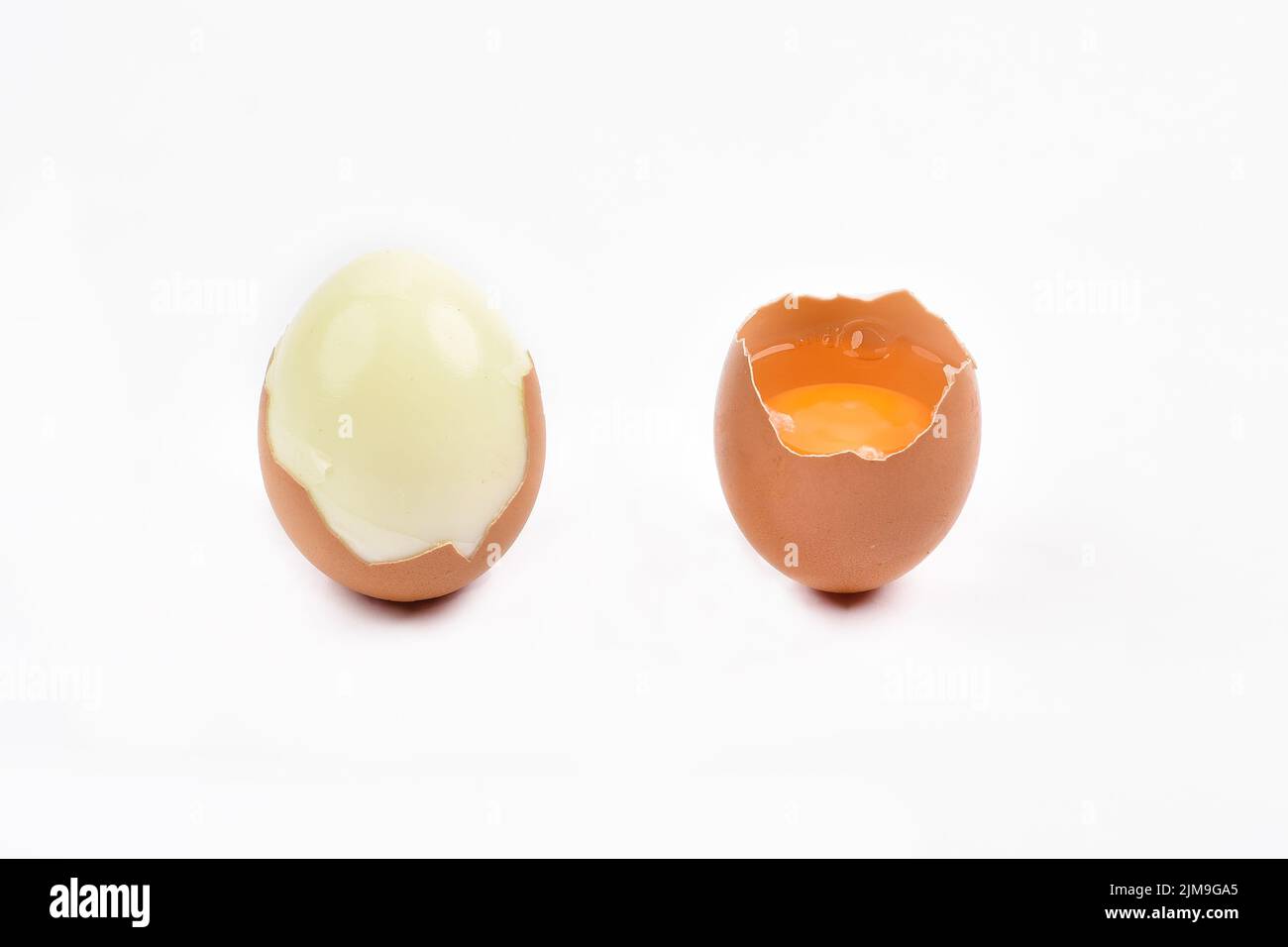 Boiled egg and uncooked raw egg with yolk Broken or open egg shell