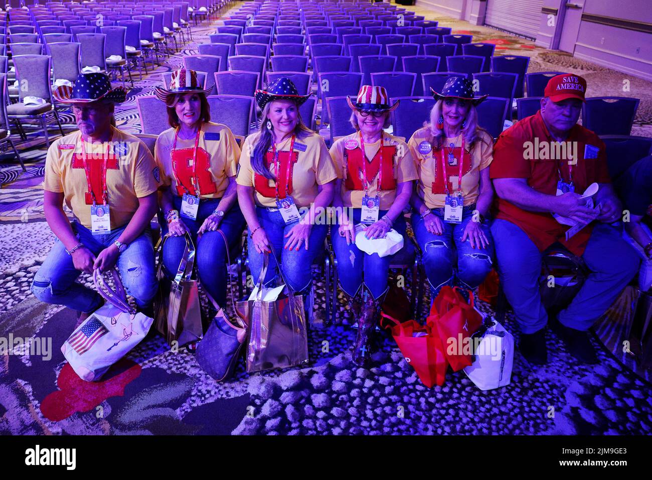 Members of the 'Trump Tribe of Texas' take their seats while wearing t-shirts spelling out 'TRUMP' for former U.S. President Donald Trump at the Conservative Political Action Conference (CPAC) in Dallas, Texas, U.S., August 4, 2022.  REUTERS/Brian Snyder Stock Photo
