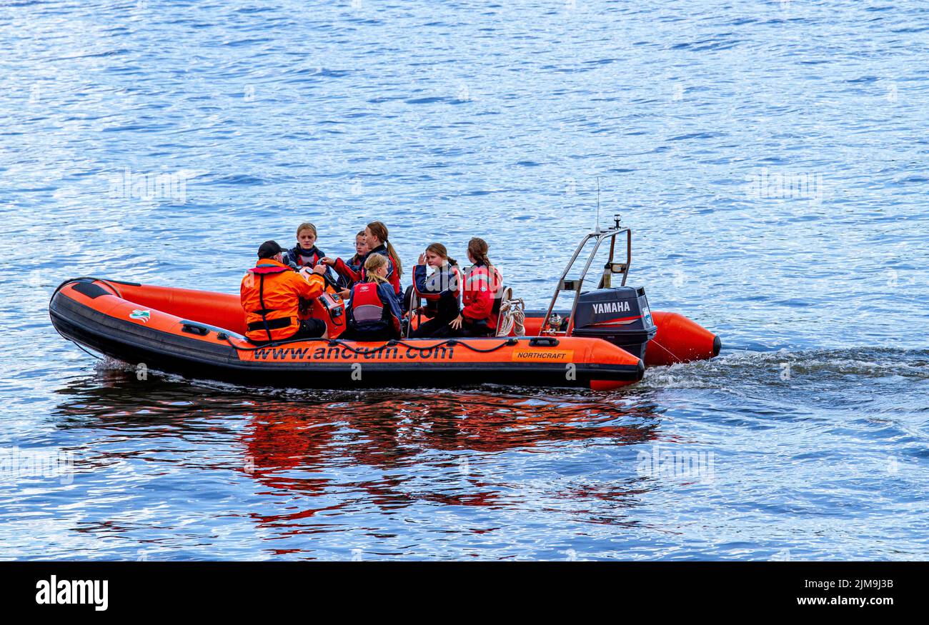 Dundee, Tayside, Scotland, UK. 5th Aug, 2022. UK Weather: A bright sunny day with temperatures reaching 18°C in North East Scotland. Local children from the Ancrum Outdoor Centre have a good time power boating on the River Tay in Dundee. Ancrum Activities offers skill development courses and coaching certification to people of all ages and abilities. Power boating Adventure (Age 8-14yrs) consists of two boats that provide hands-on experience at the helm under the expert supervision of powerboat instructors. Credit: Dundee Photographics/Alamy Live News Stock Photo