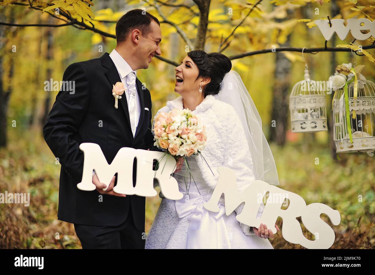 Mrs. Photo Happy wedding couple in autumn day with sign mrs mr Stock Photo - Alamy