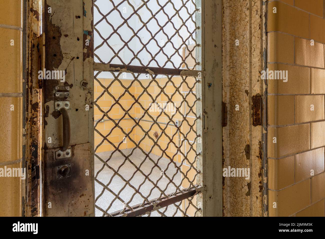 Locked barred door inside Trans-Allegheny Lunatic Asylum Stock Photo