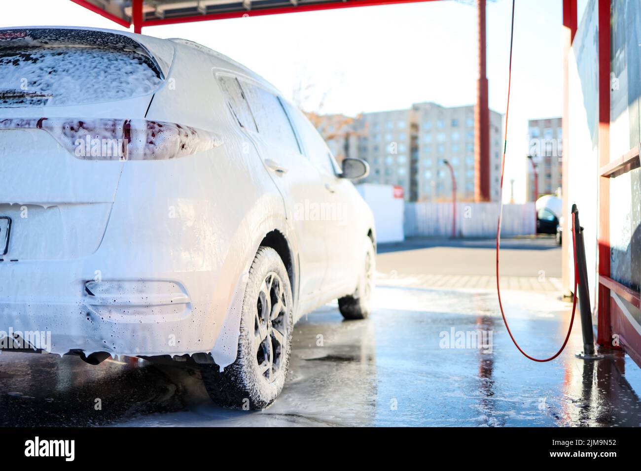 Manual car wash with pressurized water in car wash outside. Summer Car