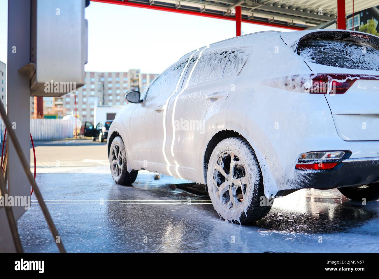 Manual car wash with pressurized water in car wash outside. Summer Car