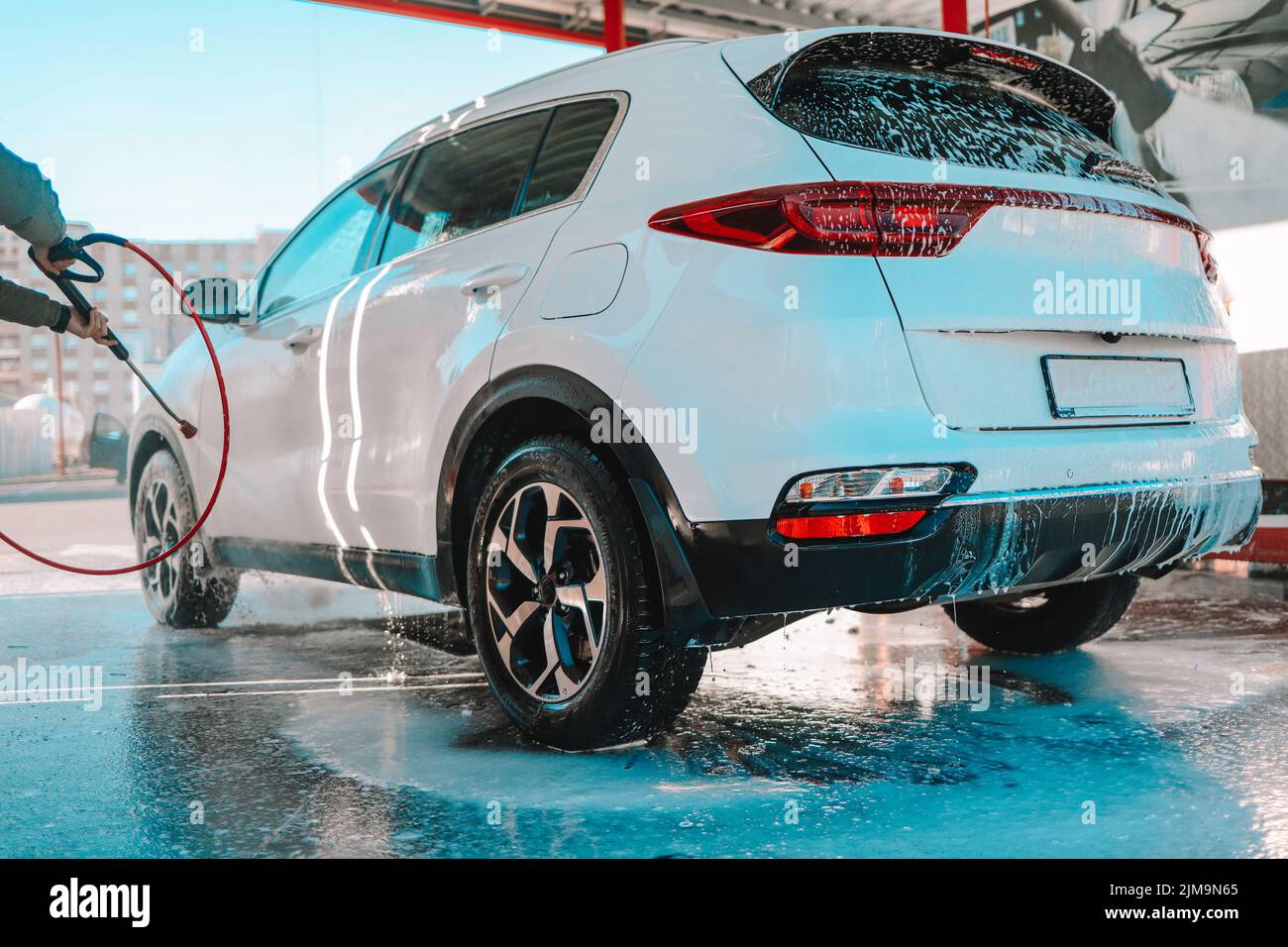 Manual car wash with pressurized water in car wash outside. Summer Car