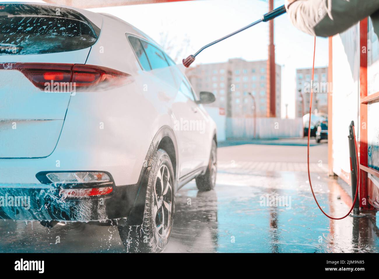 Manual car wash with pressurized water in car wash outside. Summer Car