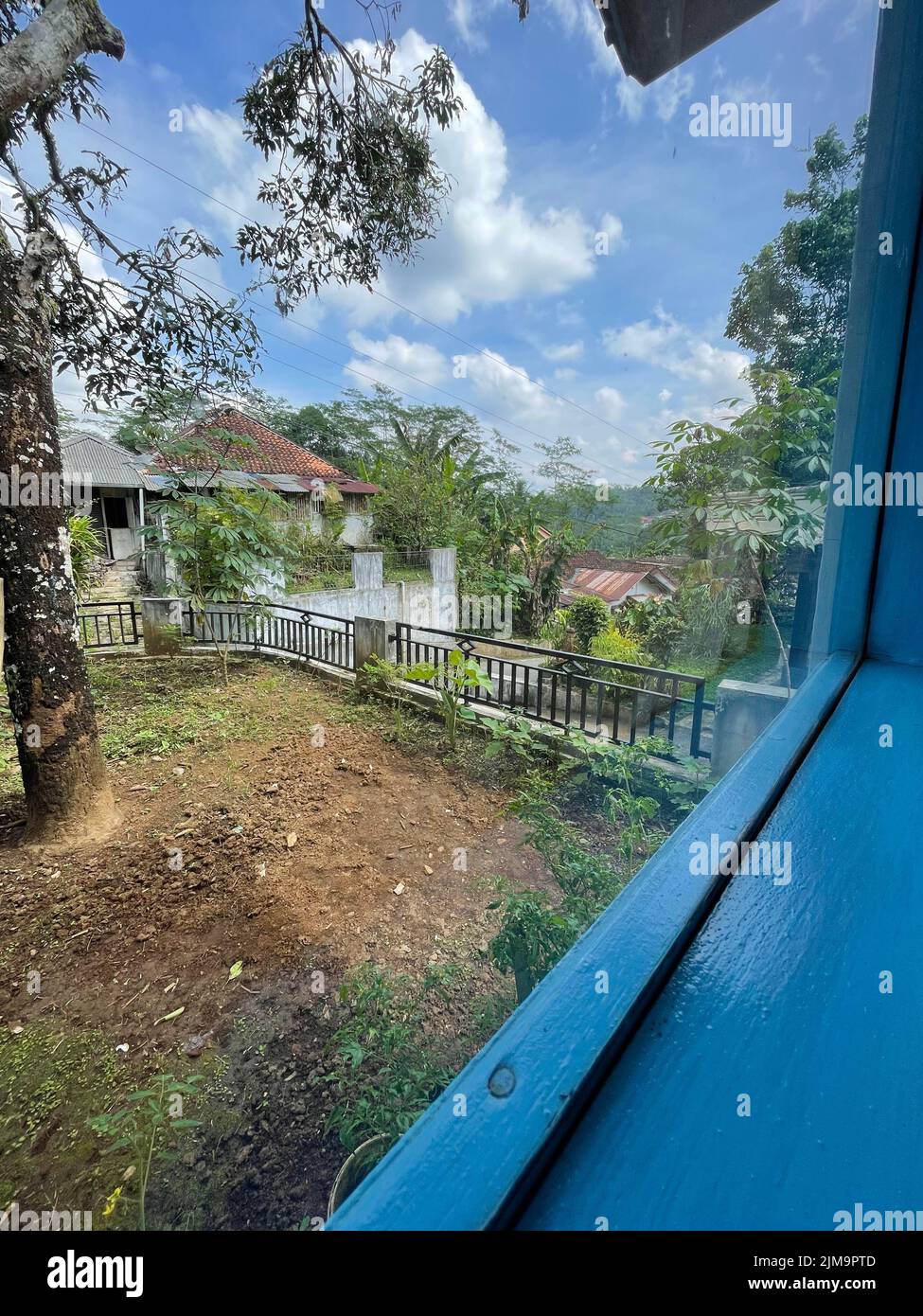 A vertical shot of garden plot with rural houses Stock Photo - Alamy