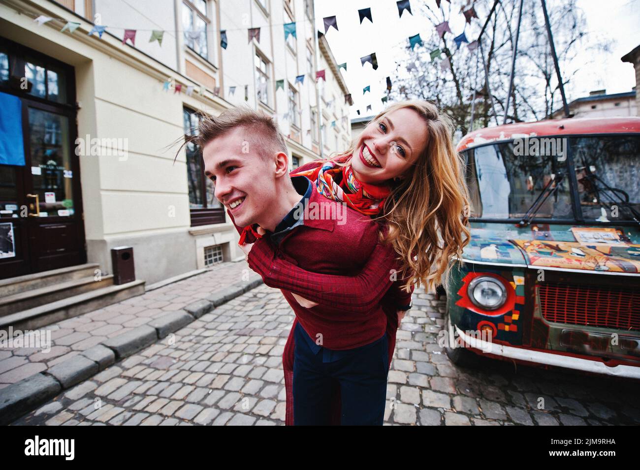 Young beautiful stylish fashion couple in a red dress in love story at