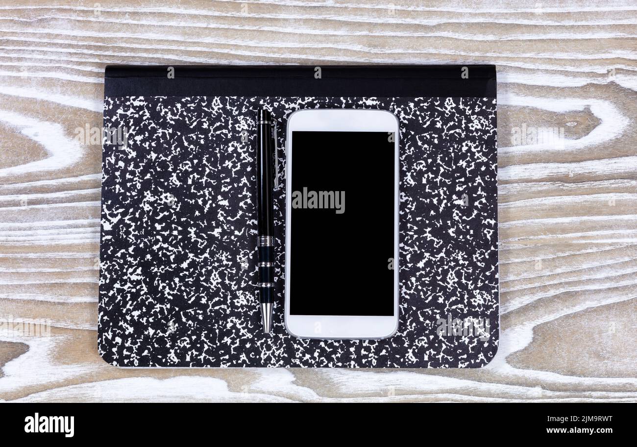 Notepad with pen and cellphone on top of old white desktop Stock Photo ...