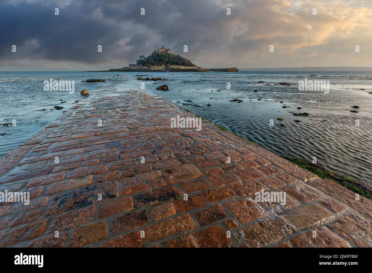 st michaels mount cornwall and flooded causeway at sunset with clearing storm no people Stock Photo