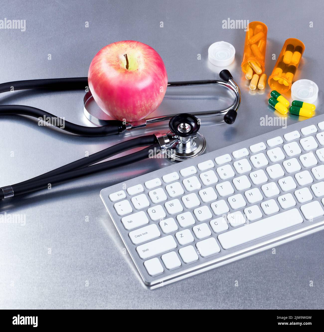 Computer and medical equipment with medicine on stainless steel exam table Stock Photo