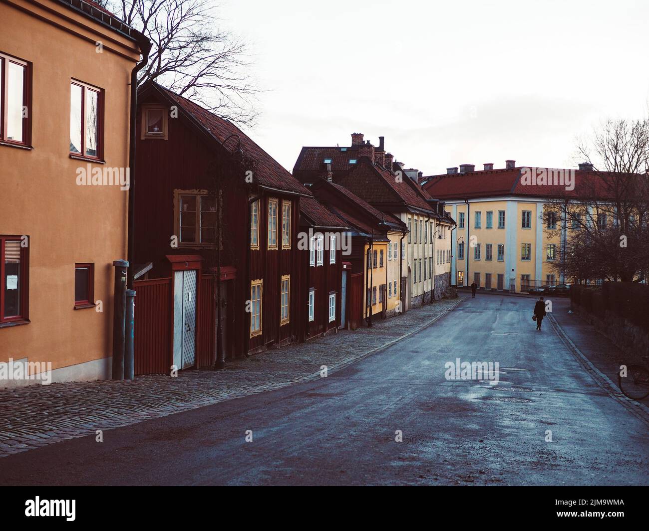 A view of colorful facade apartment buildings in a row on a rainy day