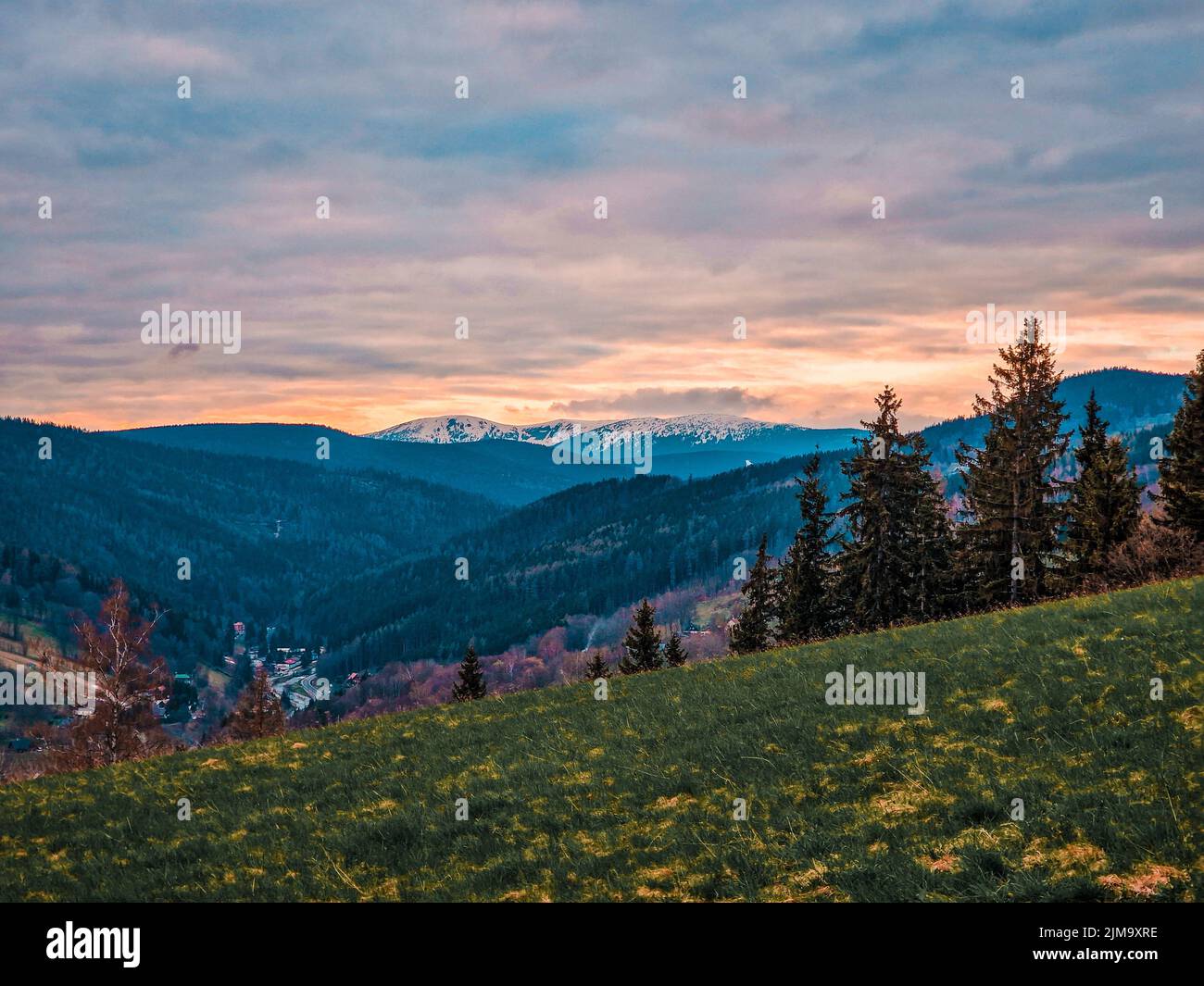 A mesmerizing view of a golden sunset over mountains Stock Photo - Alamy