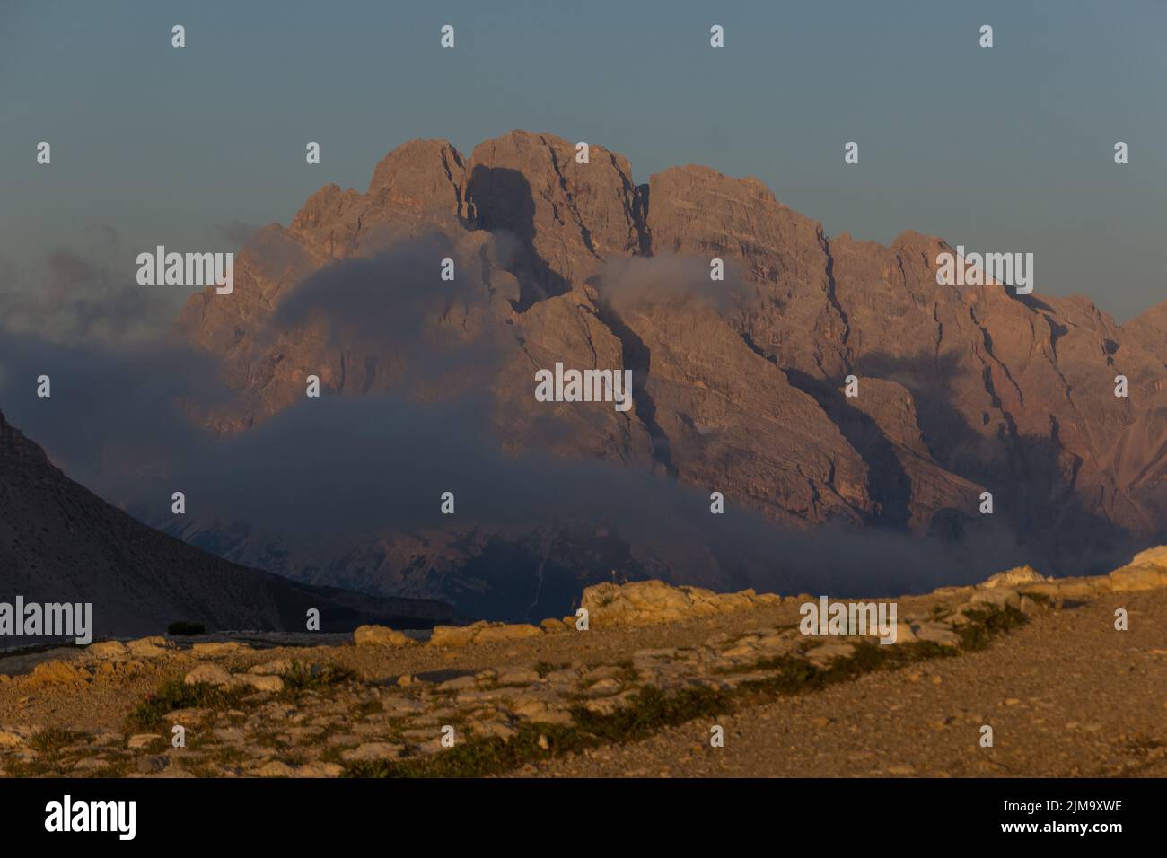 A mesmerizing view of a golden sunset over mountains Stock Photo - Alamy