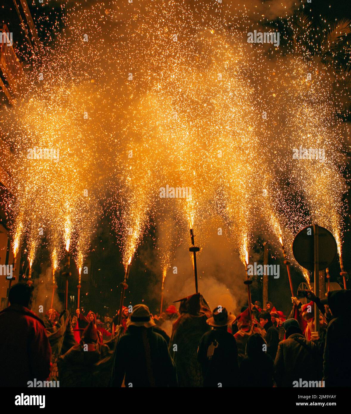 A group of people celebrating the Catalan Correfoc at night in Sant ...
