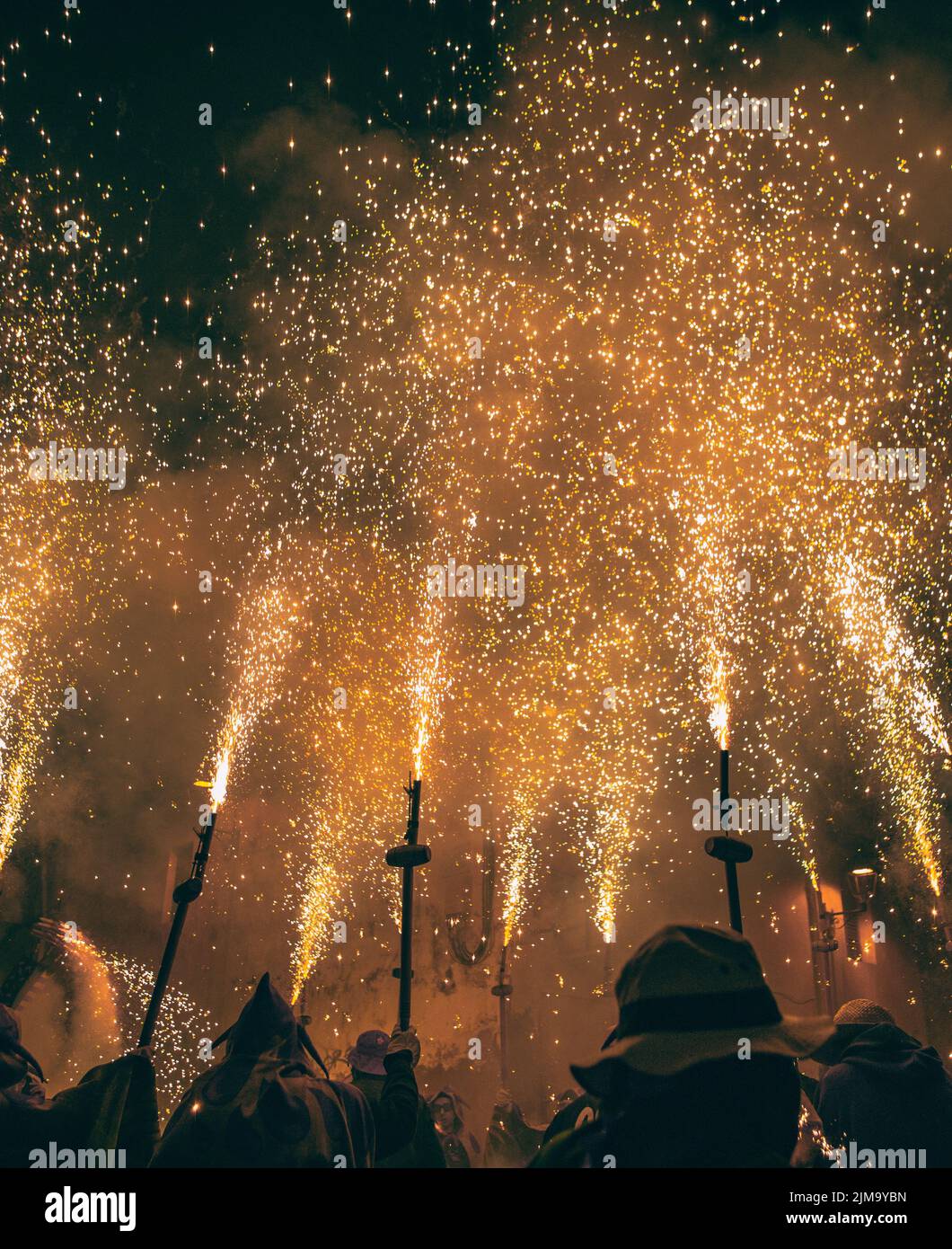 A group of people celebrating the Catalan Correfoc at night in Sant ...