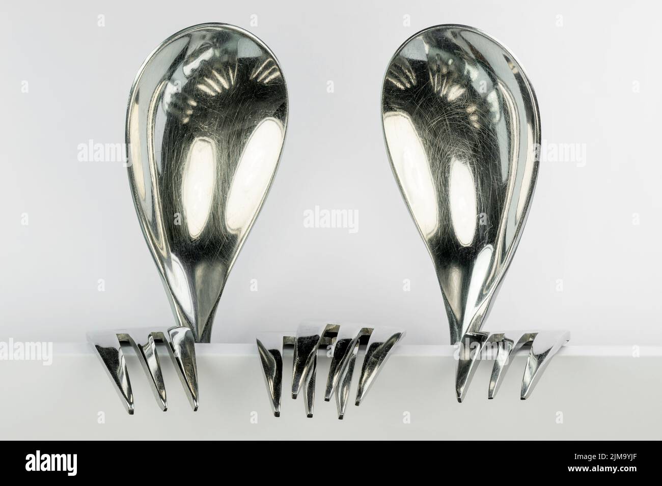 Two figures made of spoons and forks Stock Photo