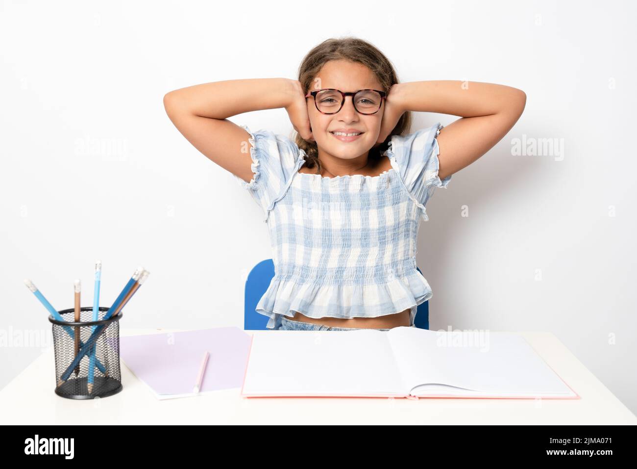 Back to school. Schoolgirl ready to learn covering ears with hands