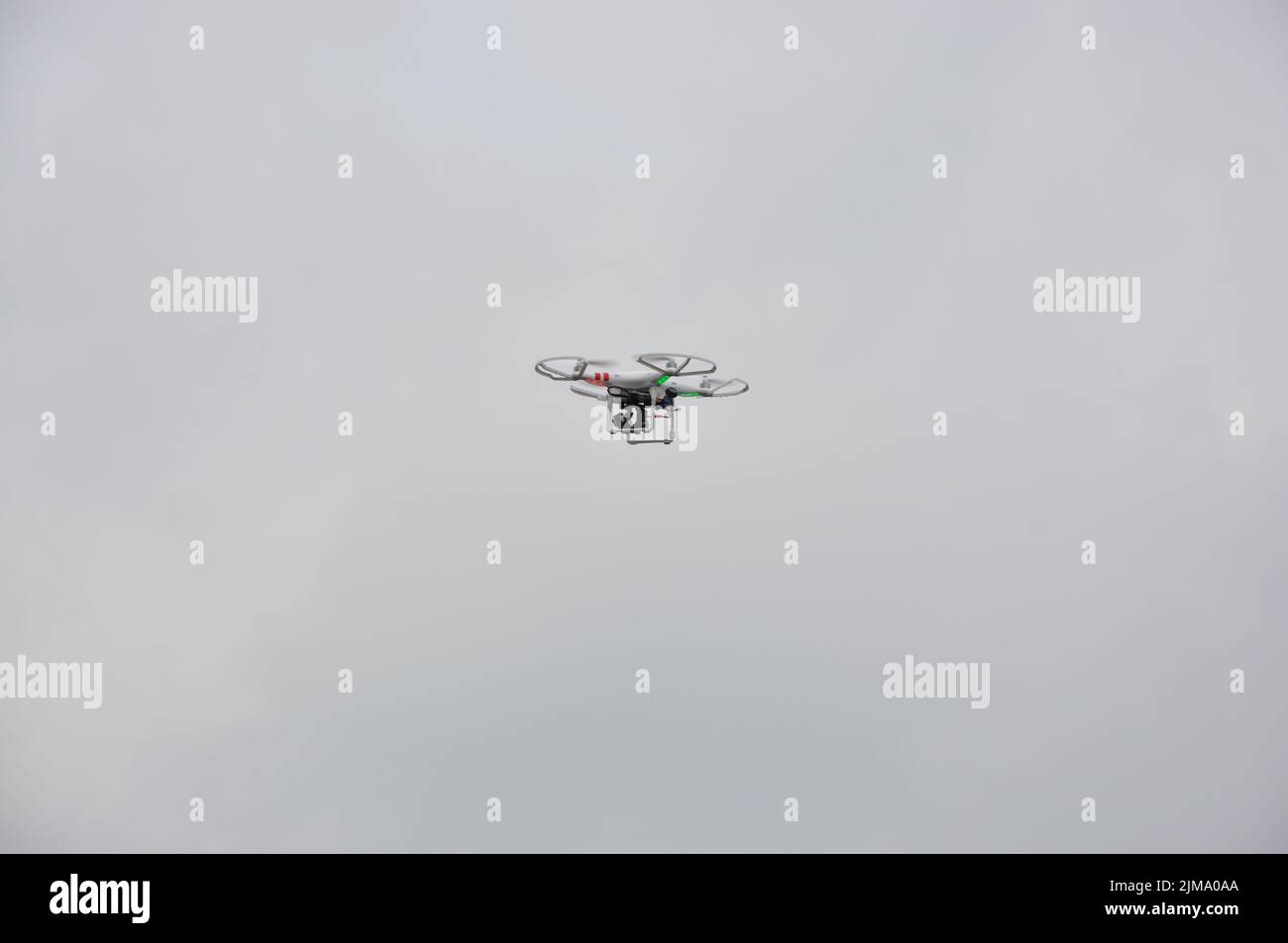 The DJI Phantom drone in the air with red and green position lights Stock Photo