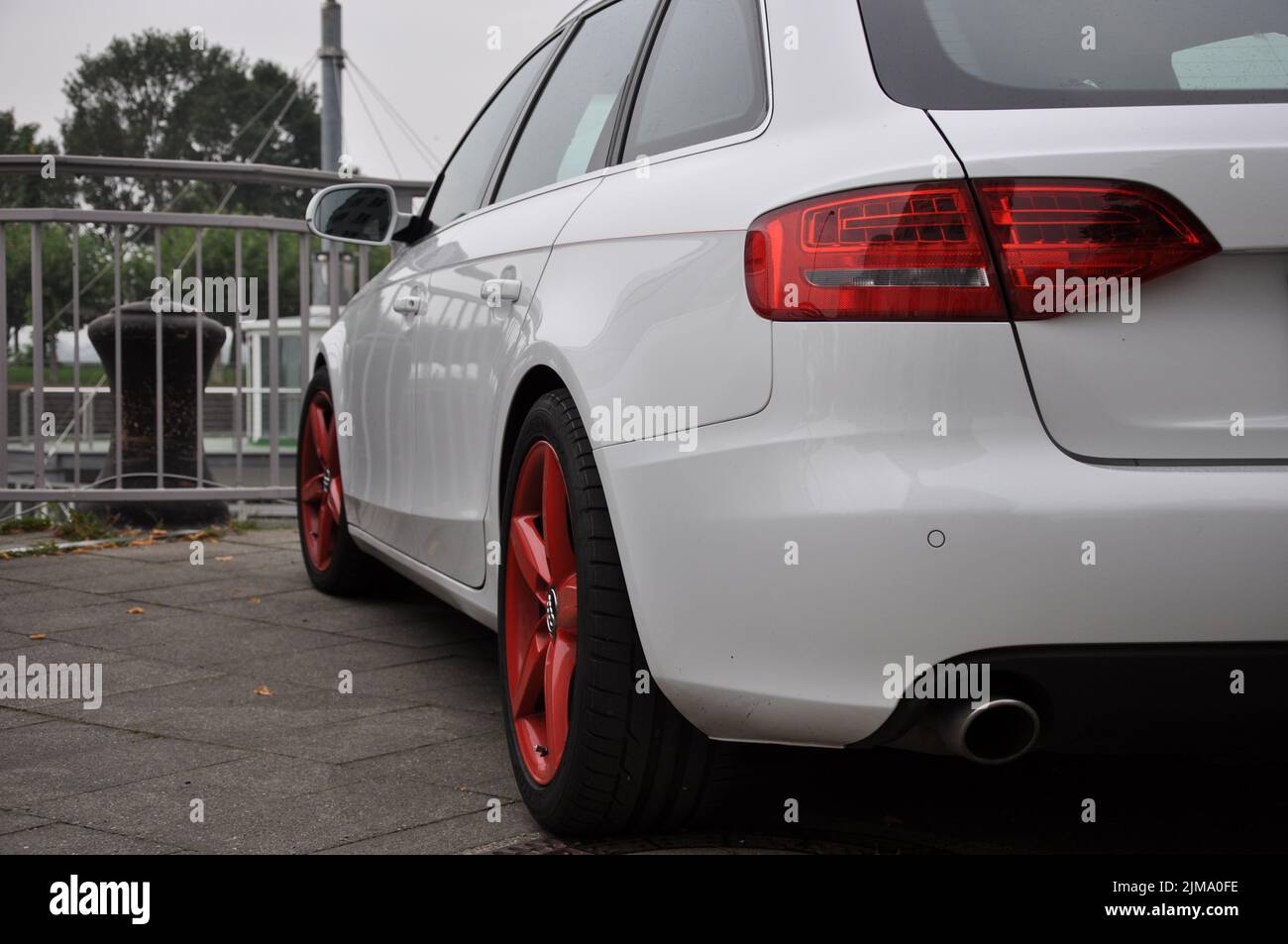 A white Audi A4 Avant with bright red rims parked on the banks of the Rhine in Dusseldorf, Germany. Stock Photo